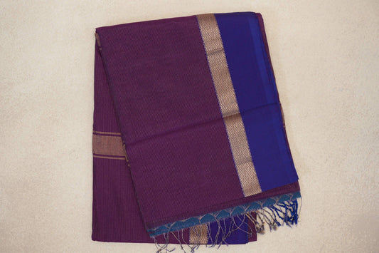 Folded Maheshwari silk cotton saree with a finely striped deep purple body, violet purple border, gold zigzag band and tasseled end.