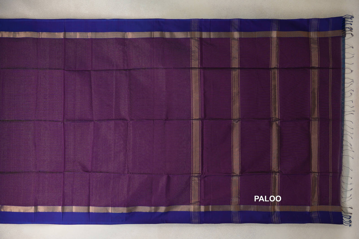 Spread Maheshwari silk cotton saree with a deep purple body, violet purple borders, and a striped pallu with tassels at the end.
