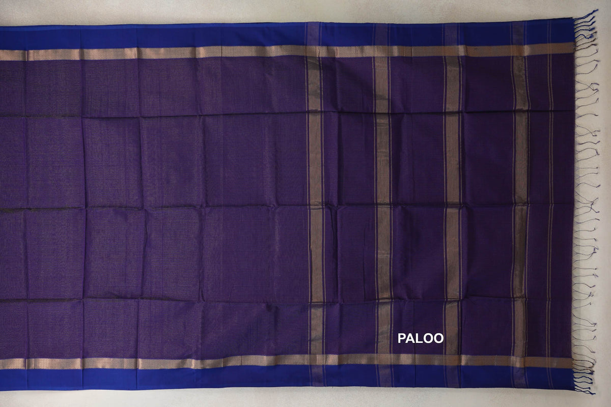 Deep Purple Maheshwari silk cotton saree laid flat, showing violet borders with metallic bands and a striped pallu with fringe.