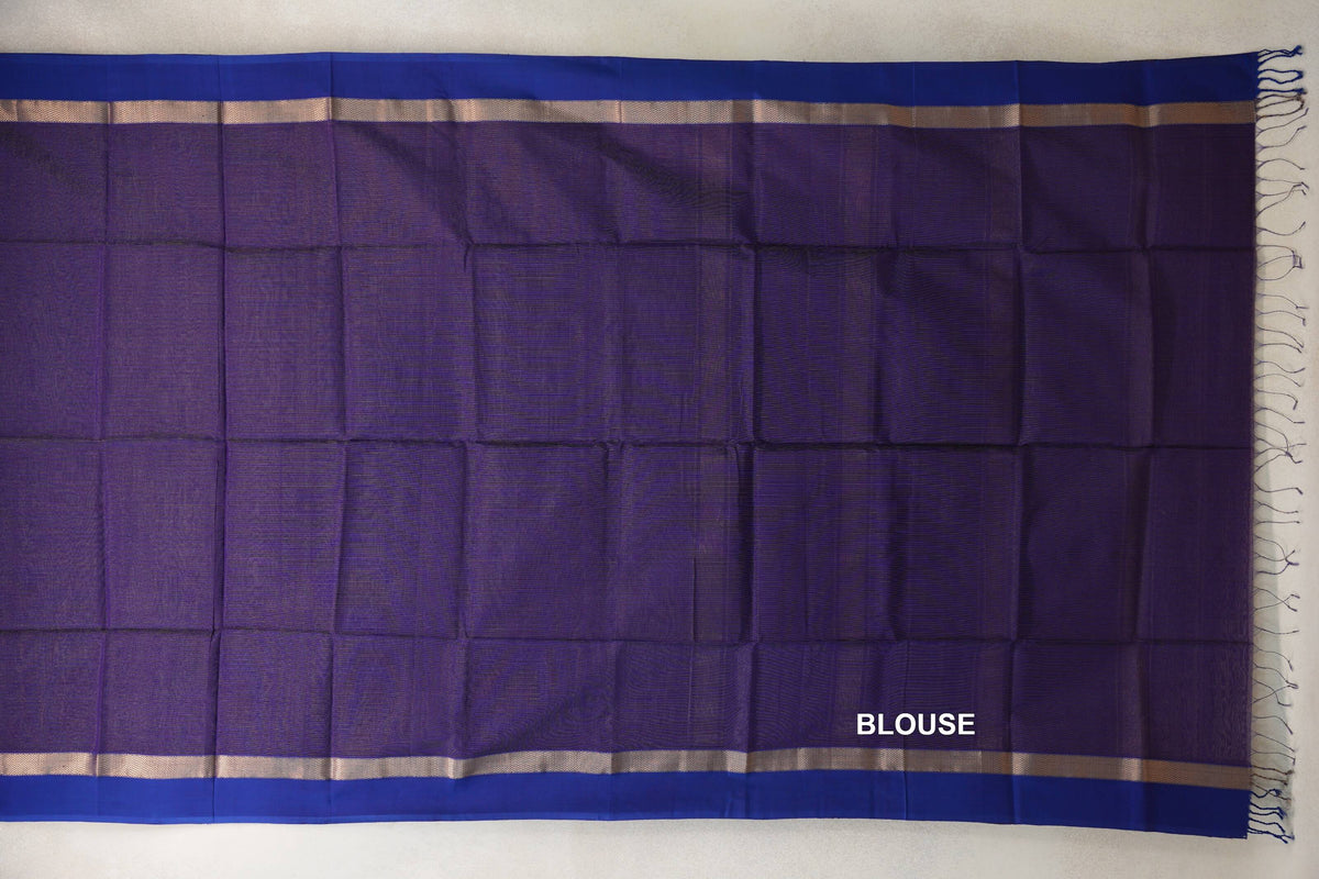 Deep purple Maheshwari silk cotton blouse piece laid flat, with violet borders, narrow gold-toned zigzag bands and tassels along one edge.