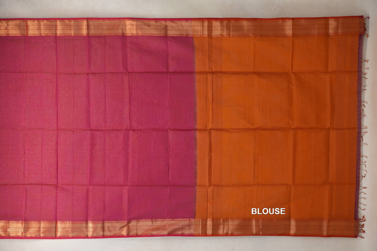 Laid-out Maheshwari silk cotton saree with a plain rani pink body, orange blouse section, gold-toned striped borders and tassels.