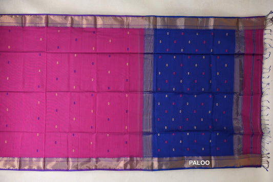 Maheshwari silk cotton saree spread flat, showing a bright rani pink body, royal blue pallu, scattered small accents and patterned royal purple borders.