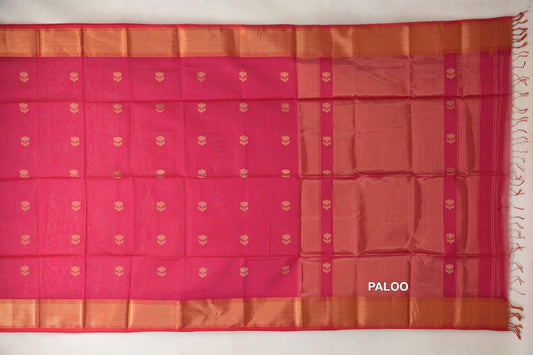 Deep Rani Pink Maheshwari silk cotton saree laid flat, showing small gold-toned floral motifs, broad woven borders and a striped pallu with tassels.