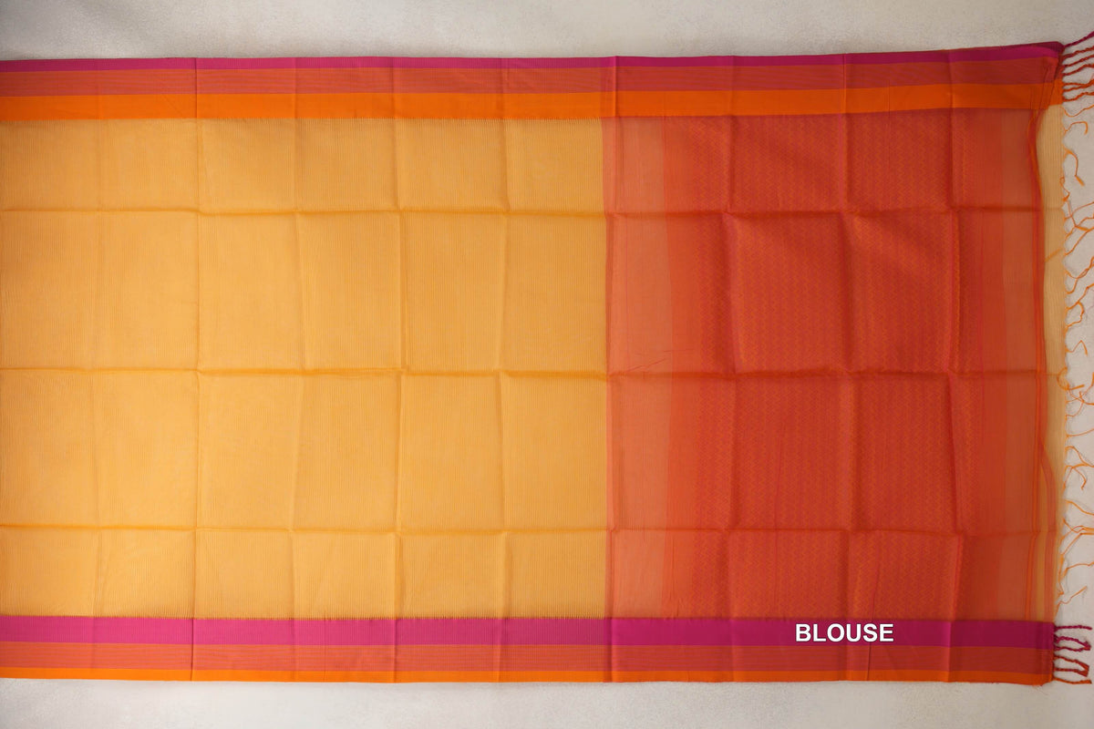 Maheshwari silk cotton saree laid flat, with a mango yellow body, pink and orange borders, and a pink-orange blouse section at right.