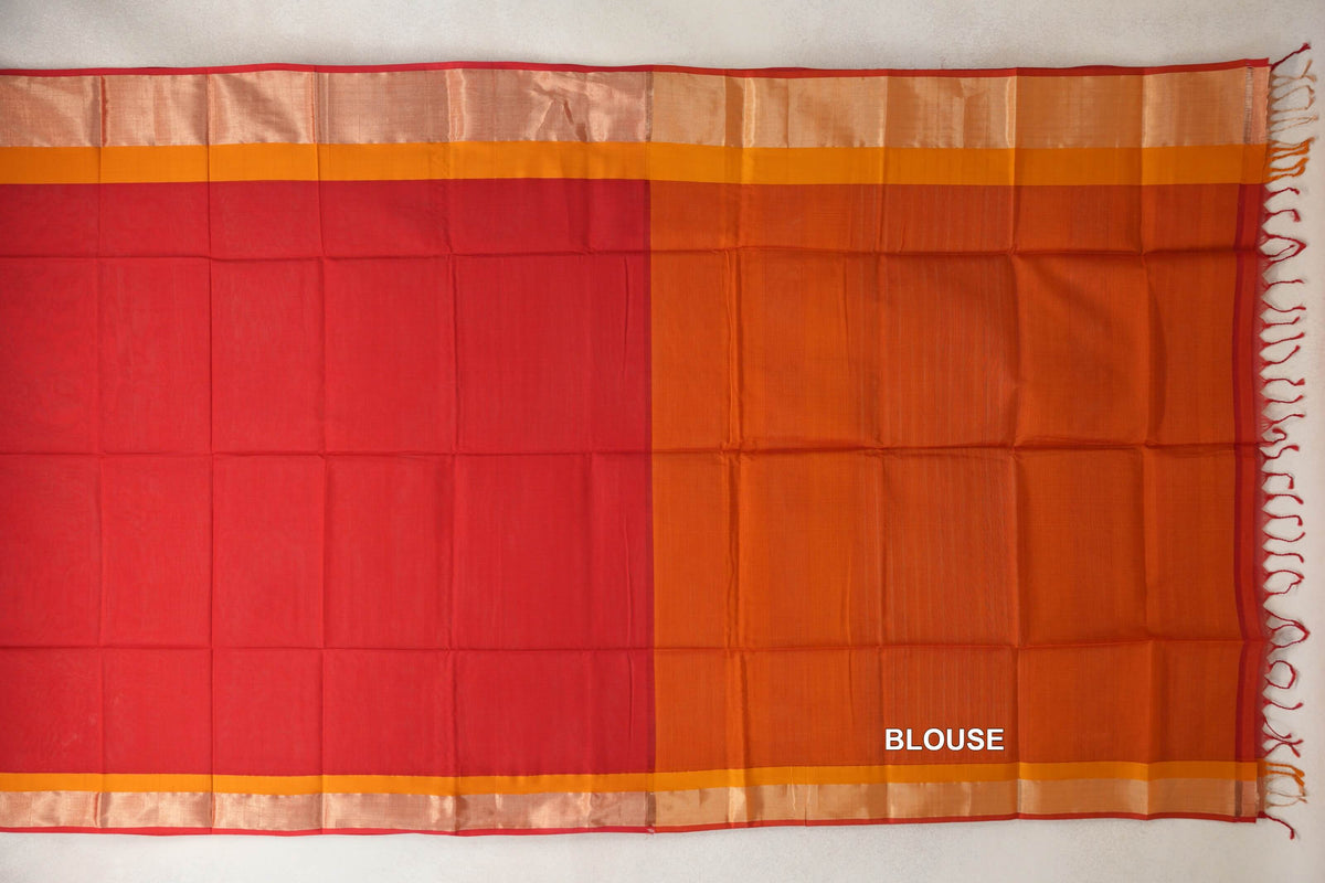 Laid-flat Maheshwari silk cotton saree showing a tomato red body beside a deep orange blouse piece, with orange borders, red selvedge and tassels.