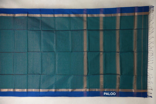 Teal green Maheshwari silk cotton saree laid flat, with royal blue borders, silver-toned bands and a striped pallu with tassels.