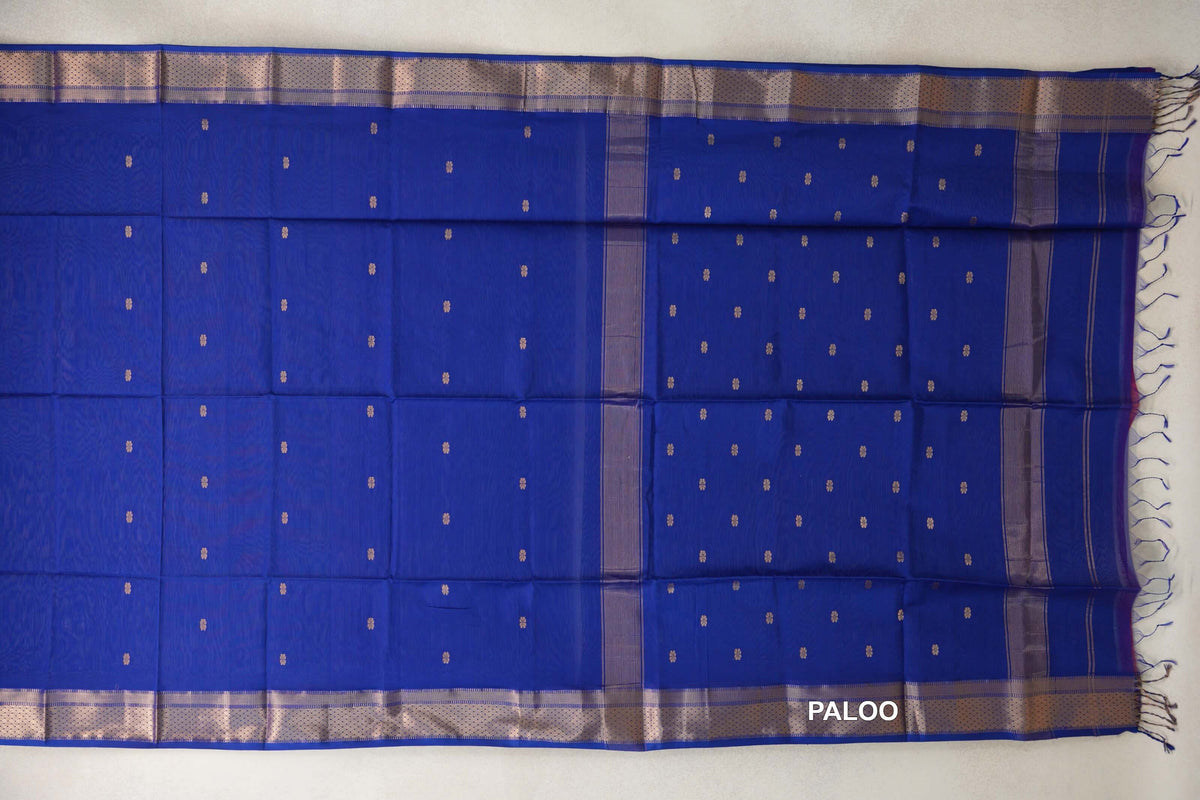 Bright Royal Blue Maheshwari silk cotton saree spread open, showing a dotted body, striped pallu panels, shimmering borders and tassels at the end.