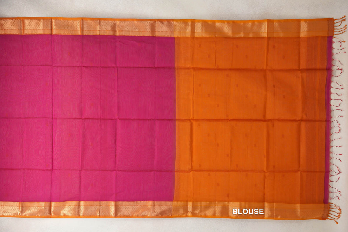 Spread-out Maheshwari silk cotton saree showing a rani pink body, deep orange borders and an attached deep orange blouse section with tassels.