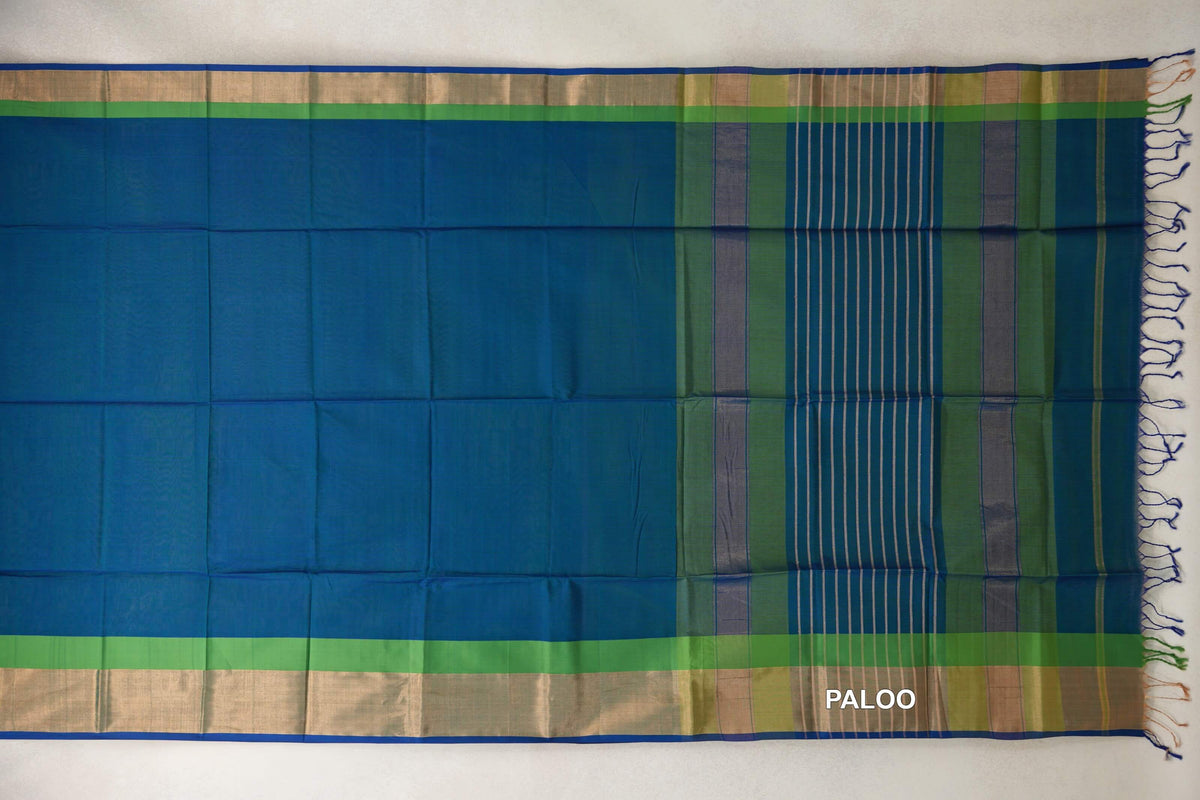 Peacock blue Maheshwari silk-cotton saree spread flat, with parrot green borders, royal blue edging and a striped Multi Color pallu with tassels.