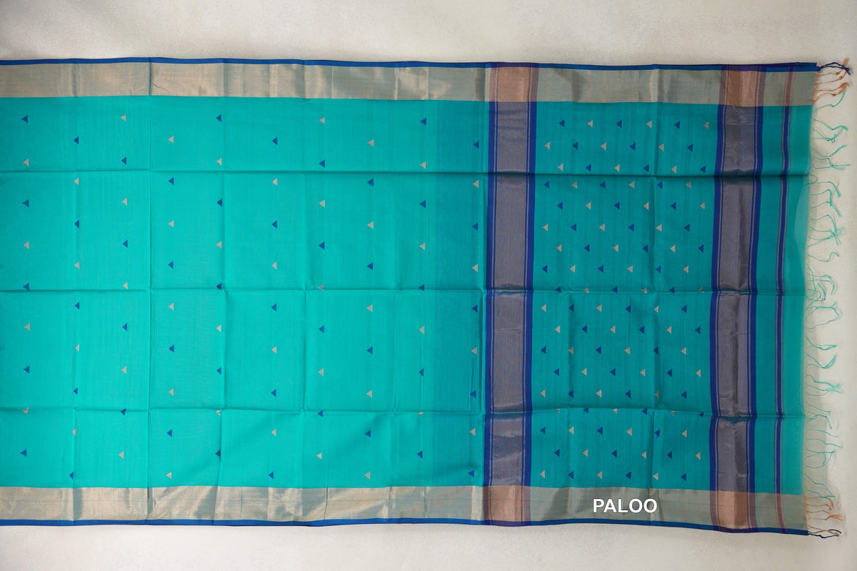 Bright Turquoise Green Maheshwari silk-cotton saree laid flat, with small triangle motifs, pale borders edged in Classic Blue, and a striped, tasseled pallu.
