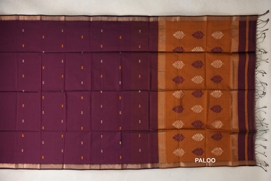 Deep Wine Maheshwari silk cotton saree laid flat with tiny motifs, gold-toned borders and a Deep Mustard Orange leaf-patterned pallu with tassels.