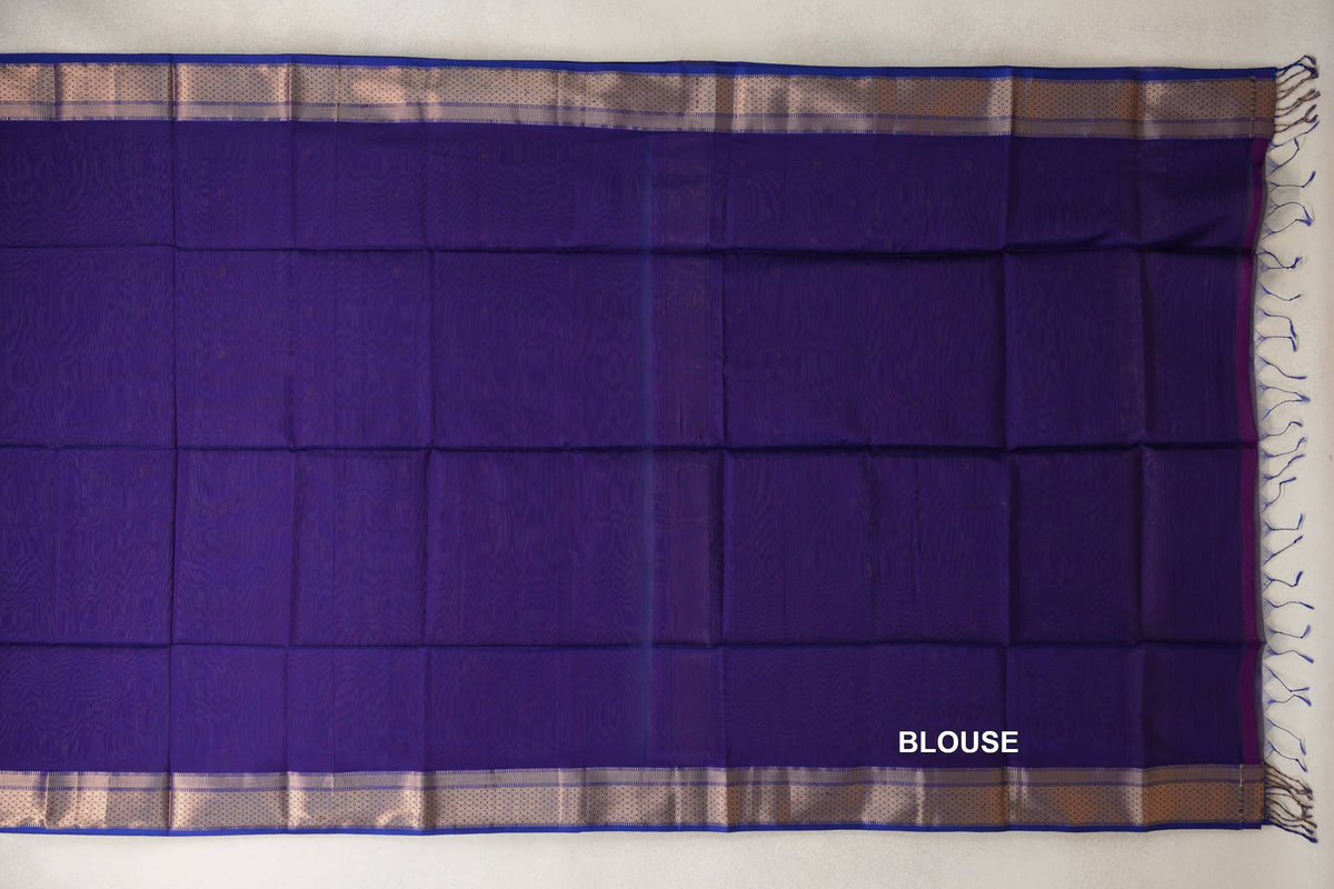 Royal Purple Maheshwari silk cotton blouse fabric laid flat, with subtle tonal texture, gold-toned patterned borders and tassels along one edge.