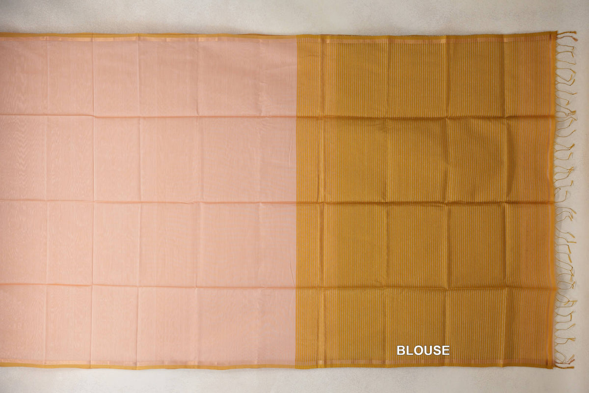 Peach Maheshwari silk cotton saree laid flat with slim light mustard gold borders and a striped blouse section with tassels on the right.