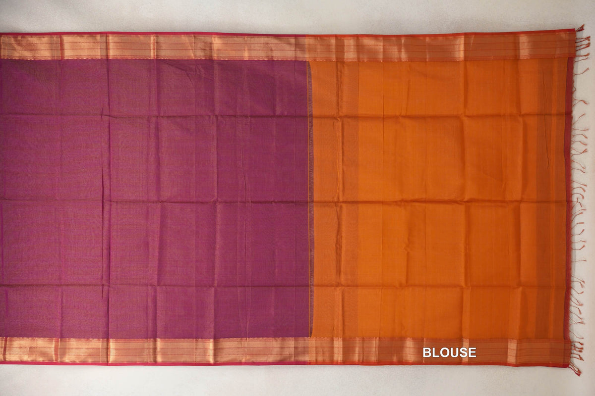 Deep magenta Maheshwari silk cotton saree body laid flat beside deep orange blouse fabric, with striped borders, pink edges and end tassels.