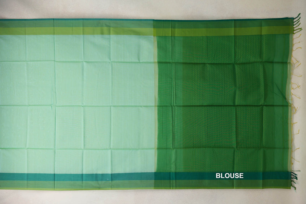 Maheshwari silk cotton saree laid flat, showing a mint green body, a parrot green blouse panel, teal green selvedge borders and end tassels.