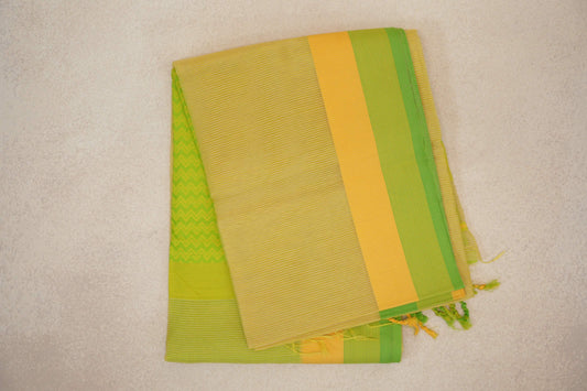 Folded lemon yellow Maheshwari silk cotton saree with fine stripes, a yellow and parrot green border, a green zigzag panel and tassels.