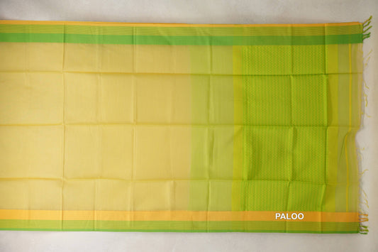 Maheshwari silk cotton saree laid flat, showing a lemon yellow body, parrot green and yellow borders, and a patterned pallu with tassels.