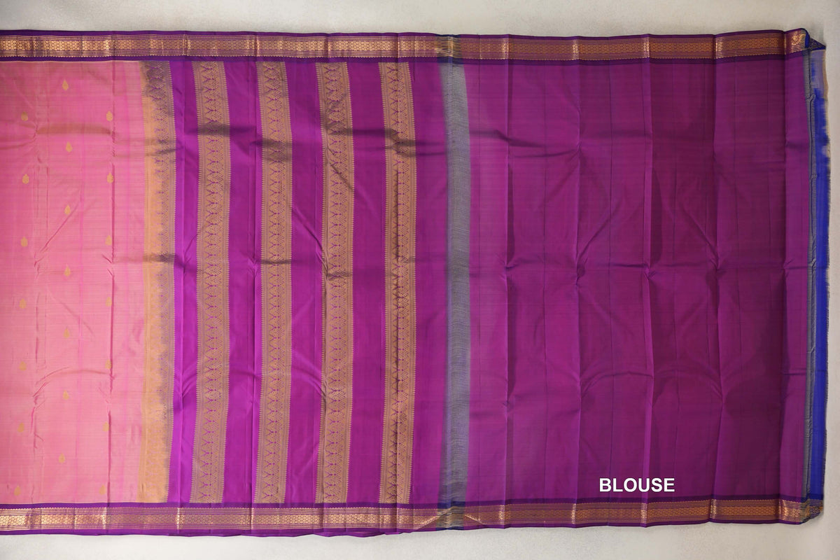 Light Weight Kanchipuram silk saree laid flat, showing a rose pink body, purple pallu with gold stripes, patterned borders and a purple blouse piece.