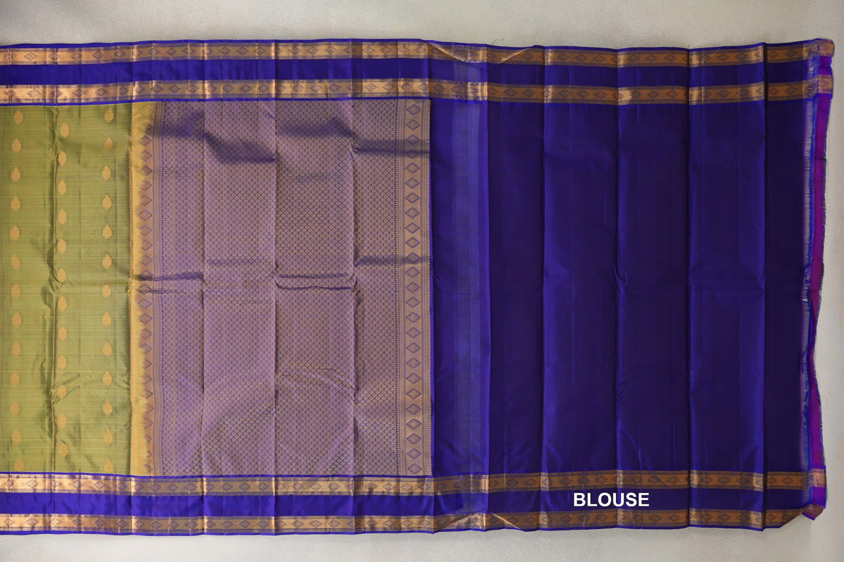 Spread-out Kanchipuram silk saree showing an olive green body with gold motifs, a patterned royal blue pallu, gold borders and royal blue blouse fabric.