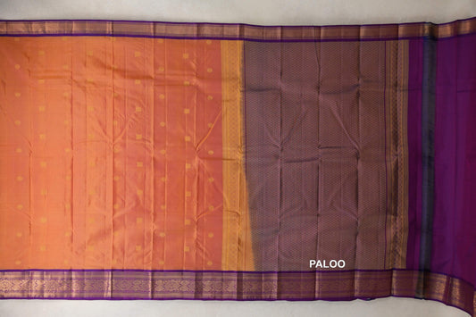 Lightweight Kanchipuram silk saree spread out, with a pink and yellow body dotted with gold motifs, deep purple borders and a patterned purple pallu.