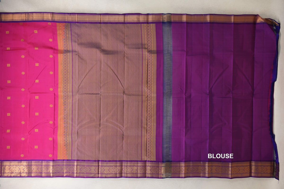 Spread-out Kanchipuram silk saree with a rani pink body, gold-patterned pallu, magenta purple blouse section and ornate gold borders.
