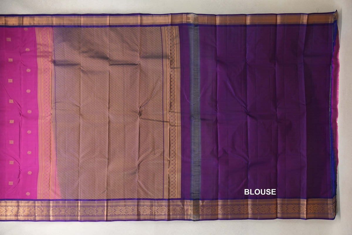 Lightweight Kanchipuram silk saree laid flat, showing a deep magenta body, gold lattice-patterned pallu and violet purple blouse piece with ornate borders.