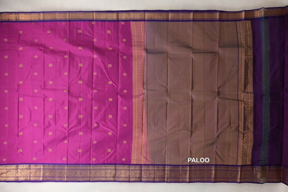 Lightweight Kanchipuram silk saree spread out, showing a deep magenta body with small gold motifs, a violet purple lattice-patterned pallu and ornate gold borders.