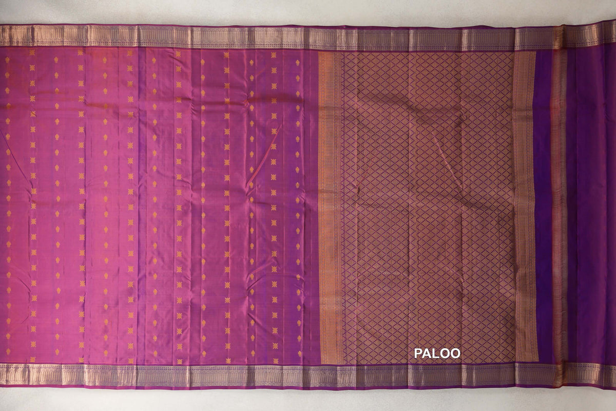 Lightweight Kanchipuram silk saree laid open, showing a blue and red body with small gold motifs, a diamond-patterned pallu and gold borders.
