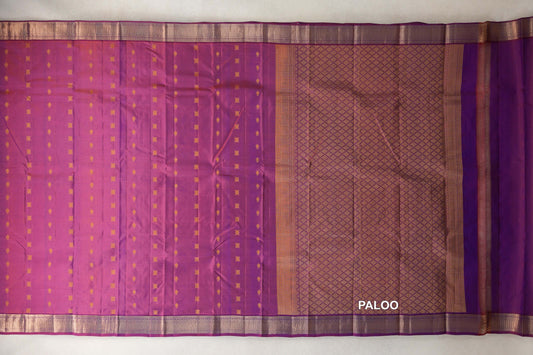 Lightweight Kanchipuram silk saree laid open, showing a blue and red body with small gold motifs, a diamond-patterned pallu and gold borders.