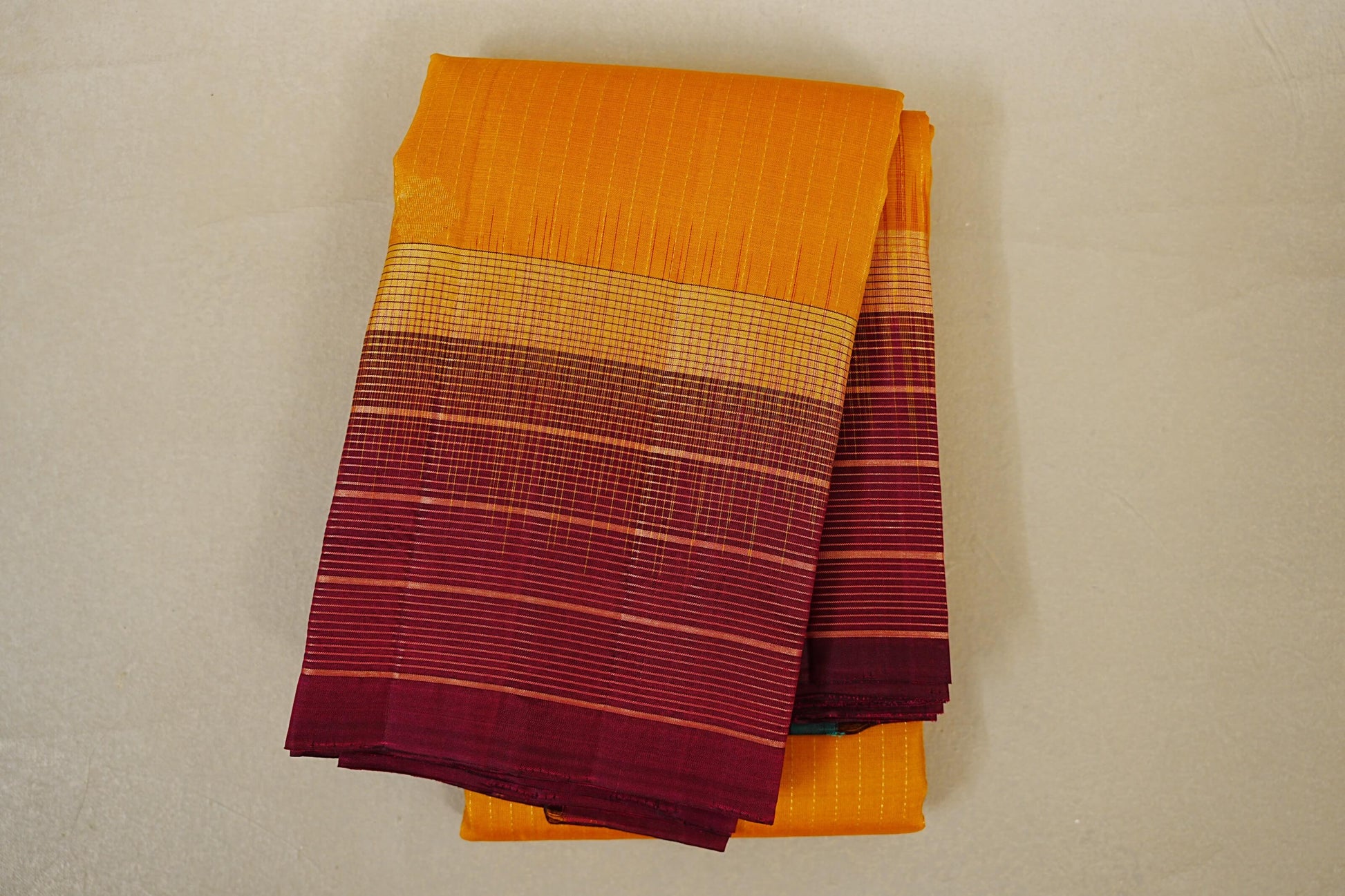 folded Mango Yellow with Deep Maroon Borders Light weight Kanchipuram Silk Saree