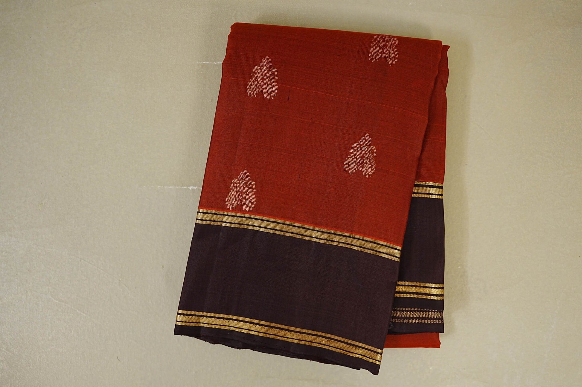 folded Reddish Rust with Dark Brown Borders Light Weight Kanchipuram Silk Saree 