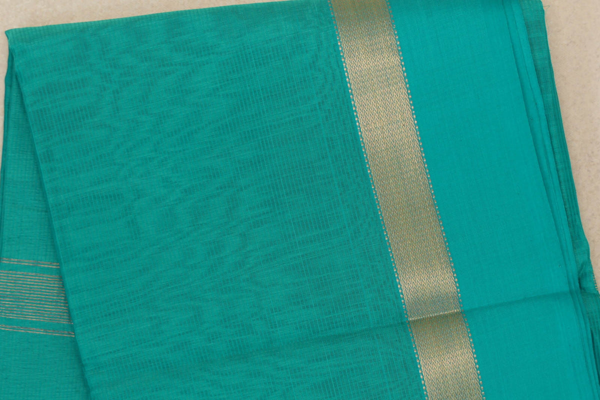Folded bright aqua green Maheshwari silk cotton saree with a fine woven texture, a wide gold-patterned border and fine gold stripes at one edge.
