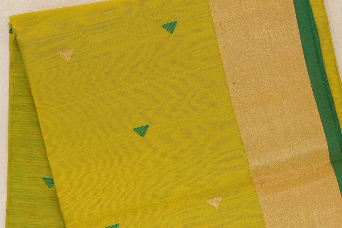 Folded Maheshwari silk cotton saree with a bright lemon yellow body, scattered green and gold triangles, and a broad gold-toned band edged in leaf green.
