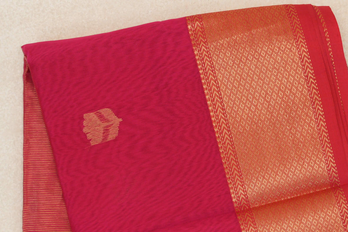 Folded Deep Rani Pink Maheshwari silk cotton saree with a small striped accent, a wide gold-toned patterned border and Pinkish Red selvedge.