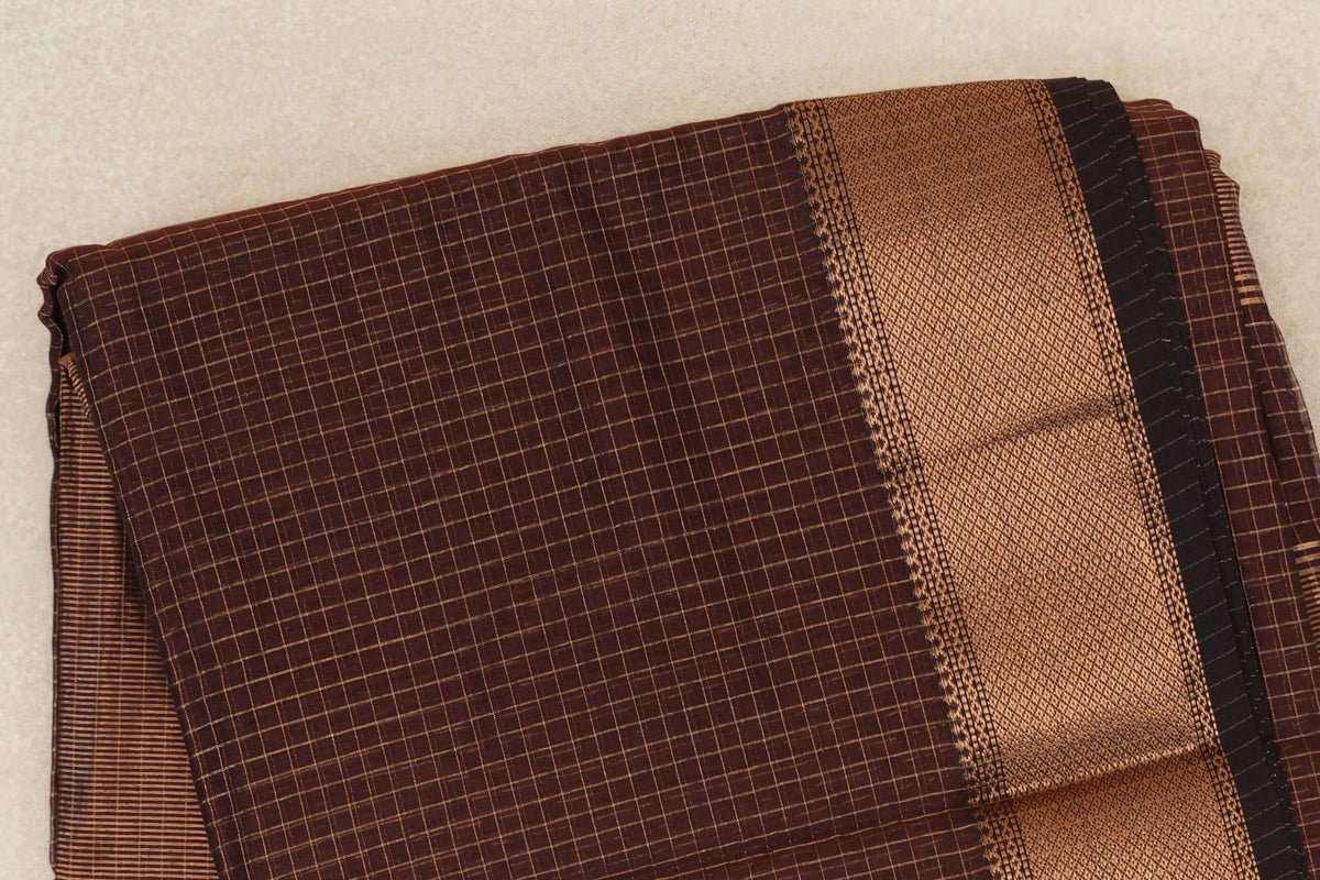 Folded Coffee Brown Maheshwari silk cotton saree with a fine checked body, a textured brown border and a Deep Coffee Brown selvedge.