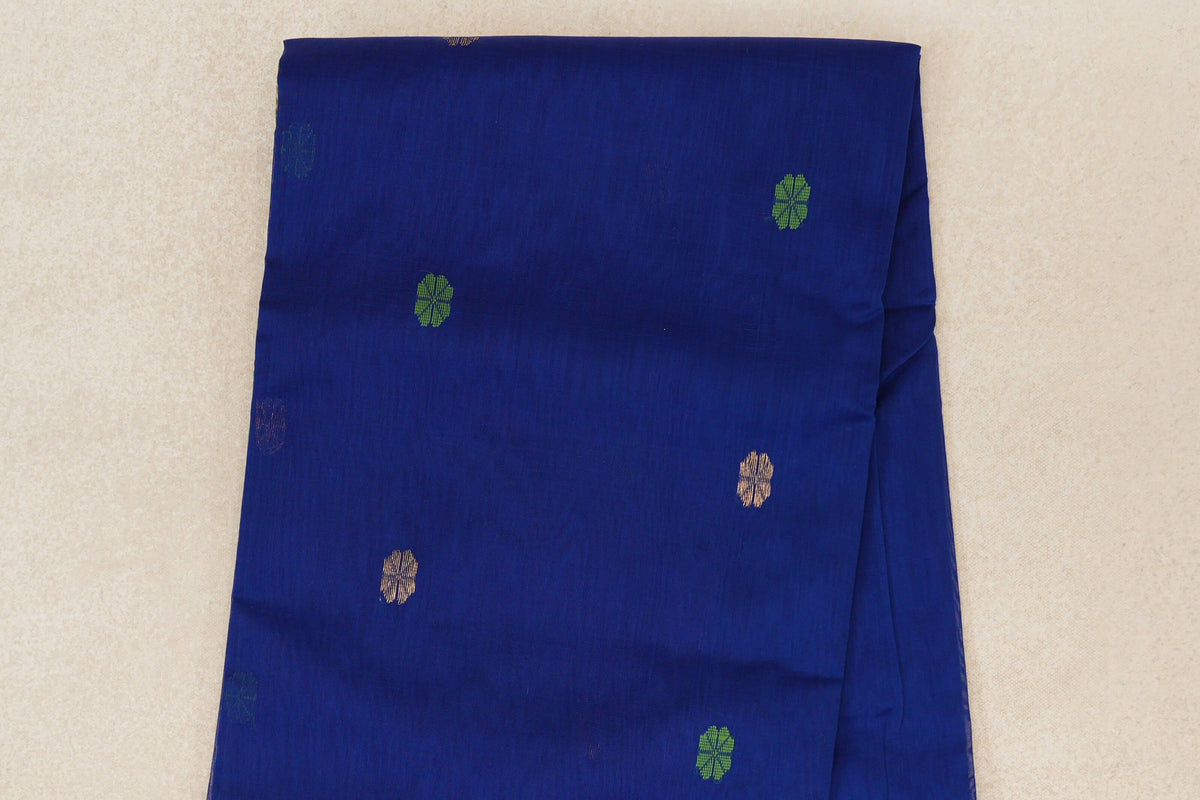 Folded close-up of a deep royal blue Maheshwari silk cotton saree body with scattered small forest green and gold-colored floral motifs.