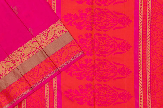 A pink silk saree with golden zari patterns and a border